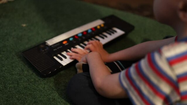 A child with hearing loss learns to play and hear sounds. High quality 4k footage