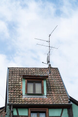 Fototapeta na wymiar radio antennas on roof of an old village house