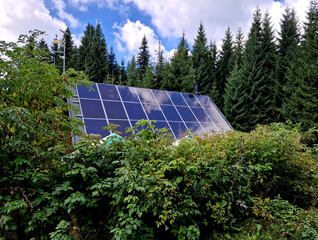 self-sufficient cottage house in the forest thanks to solar panels covering the roof in the mountains. production for own use. Scandinavian Nordic living alone