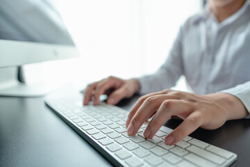 hands of doctor typing on keyboard to record patient medical history at hospital. hands adult typing on computer keybord.