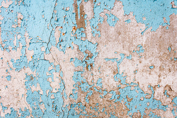 Antique concrete wall painted with blue paint with cracks as texture, pattern, background