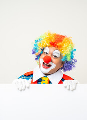 Mr Clown. Portrait of Funny face Clown man in colorful uniform standing holding copy space. Happy expression male bozo in various pose with frame mockup blank space on isolated background.