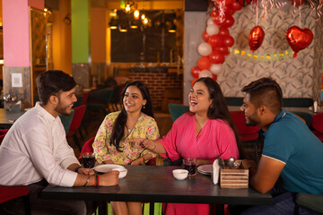 Friends celebrating birthday at restaurant