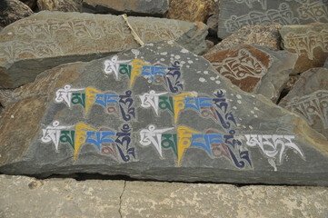 Engraved stones with Buddhist mantra Om Mani Padme Hum in Ladakh, INDIA 