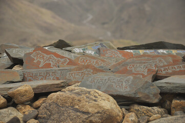 Stones inscribed with Buddhist mantra Om Mani Padme Hum in Ladakh, INDIA 