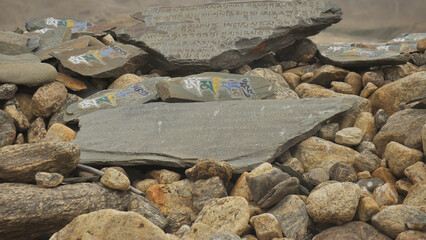 Stones inscribed with Buddhist mantra Om Mani Padme Hum in Ladakh, INDIA 