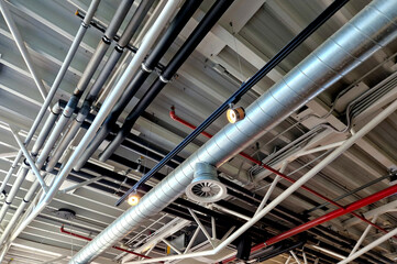 the air handling unit is on the ceiling of the building and is visibly left uncovered. the lights...