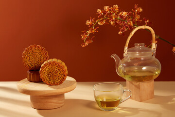 Over dark red background, Mooncake Yolk Pastry displayed with a transparent tea set. Captivating Visual Journey through the Traditions of the Mid-Autumn Festival in China