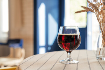 Still life of glass with dark beer. Close-up of drink on table - obrazy, fototapety, plakaty