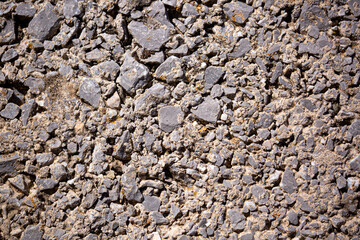 Stone antique old wall as a background or texture. Vintage background of a fortress wall in loft and grunge style with place for text and copy space.