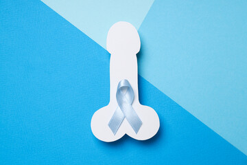 Blue ribbon with paper male genitals, Movember concept