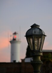 
old lighthouse and lantern at sunset