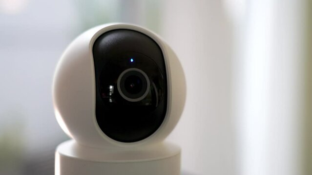 in the living room. Home security cameras are filming around controlled by a smartphone. The robot's home security camera scans its surroundings. A smart home surveillance system that works remotely.