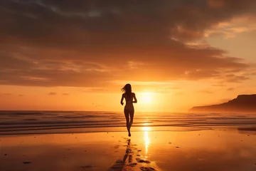 Tuinposter Ochtendgloren woman running on the beach at sunrise