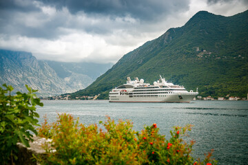 A big unrecognizable cruise ship traveling in the Bay of Kotor