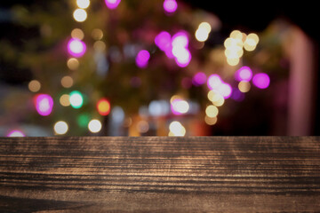 christmas tree bokeh blurred colorful lights or diwali celebrations table top wooden plank front...