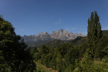 Mountainous landscape in summer with valley and vegetation.
