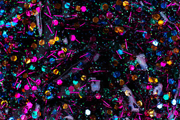 Colorful glitter sparkle confetti background. Dark multicolored glitter paint
