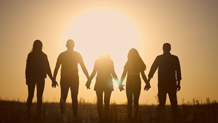 teamwork. team community a holding hands together silhouette at unity sunset. group of people hands. teamwork of workers. team in lifestyle the company running partnership business community hand