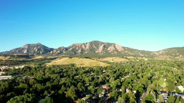 Slow rising Drone shot of Boulder, Colorado, USA on a summer morning with the flat irons in the background
