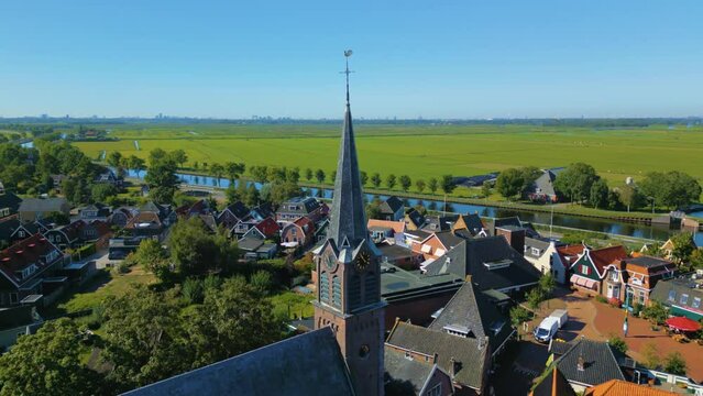Fixed shot of protestant church spire in North Holland countryside town