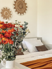 Bouquet of orange chrysanthemums in bedroom