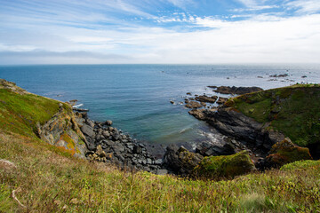 Fototapeta na wymiar Lizard, Cornwall, UK - August, 2023: View of Lizard Point in Cornwall - the most southern point of England's mainland. Copy space in sky.