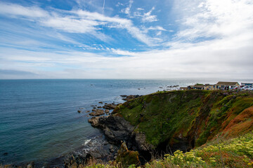 Fototapeta na wymiar Lizard, Cornwall, UK - August, 2023: View of Lizard Point in Cornwall - the most southern point of England's mainland. Copy space in sky.