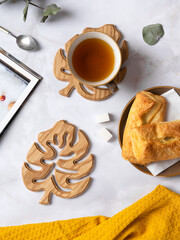 Wooden coasters for hot drinks in the shape of a monstera leaf. Decorative element, natural wood. view from above