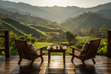 wooden terrace with wooden chairs coffee mugs on the table landscape view of terraced rice fields and mountains is the background in morning warm light