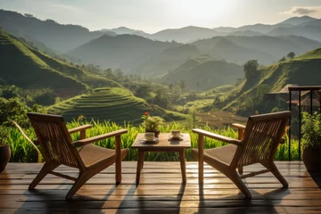 Foto op Canvas wooden terrace with wooden chairs coffee mugs on the table landscape view of terraced rice fields and mountains is the background in morning warm light © Attasit