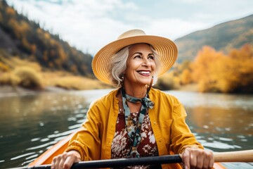 senior woman in hat paddling hat kayak gracefully