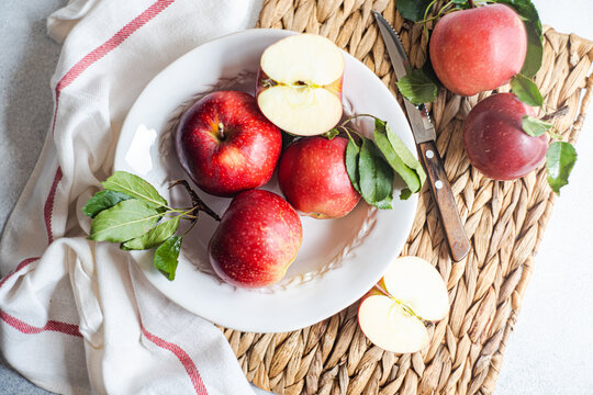 Overhead view of a plate of ripe red apples on a table mat