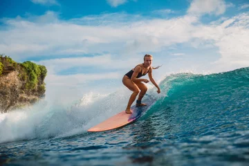 Foto op Canvas Woman in ocean during surfing. Surfer on longboard and ocean wave © artifirsov