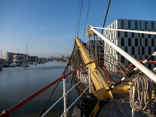 View of the harbor in Bremerhaven, Germany from the bow of a historic sailing vessel