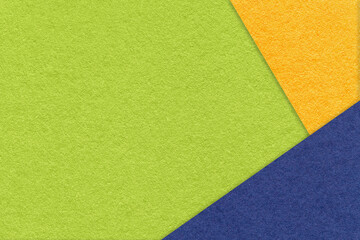 Texture of craft green color paper background with yellow and blue border. Vintage abstract cardboard.