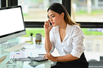 Upset asian businesswoman looking at laptop, frustrated about business failure in office