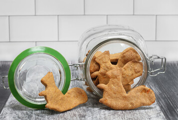 Dog cookies, squirrel shaped, and cookie jar on side.