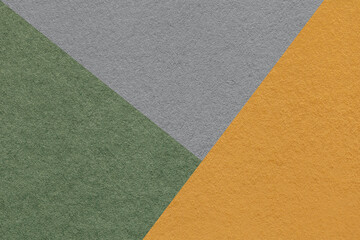 Texture of craft dark gray, green and orange shade color paper background, macro. Vintage abstract cardboard
