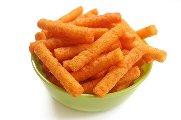 Snack stick spicy crunchy corn balado flavor in a green bowl isolated on white background