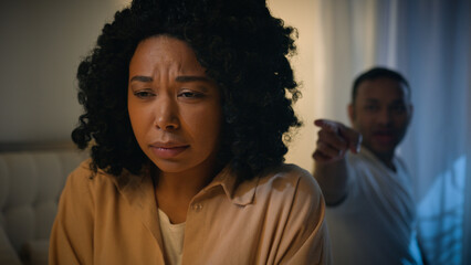 African American woman victim wife girlfriend crying scared afraid upset listening screaming man...
