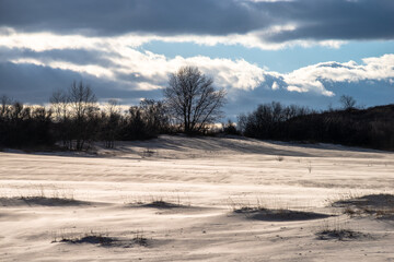 Beautiful sunset over the career with sand in winter. 