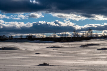 Beautiful sunset over the career with sand in winter. 