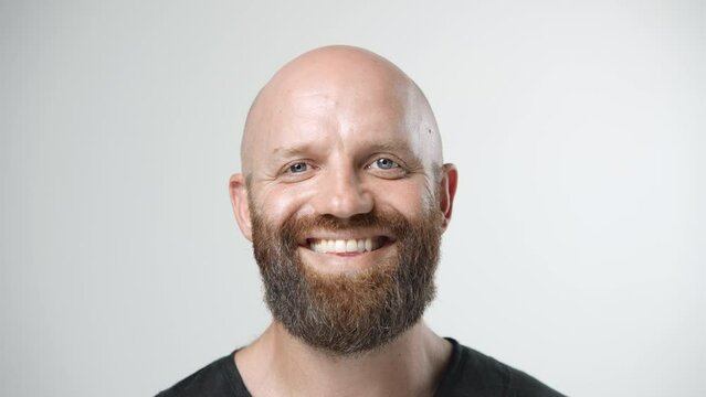 Handsome person look at camera close up. Young adult man face portrait. Stylish 30s guy on isolated white background. Attractive male model. Modern millennial people. Brutal bearded style. Barber shop