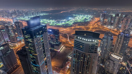 Panorama of Dubai Marina with JLT skyscrapers and golf course night timelapse, Dubai, United Arab...