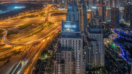 Dubai marina and JLT skyscrapers along Sheikh Zayed Road aerial all night timelapse.