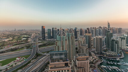 Fototapeta na wymiar Panorama showing Dubai marina and JLT skyscrapers along Sheikh Zayed Road aerial timelapse.