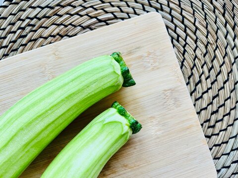 Overhead view of two courgettes on a chopping board