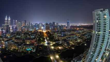 Fototapeta na wymiar Panorama with skyscrapers in Barsha Heights district and low rise buildings in Greens district aerial day to night timelapse.