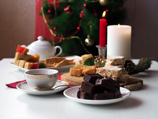 Almond and chocolate turron and fruity nougat. Burning candles